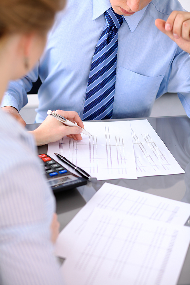 Bookkeepers or financial inspector making report, calculating or checking balance. Audit concept.