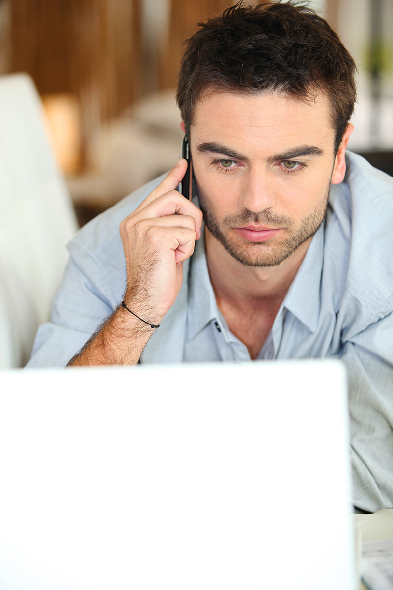 Serious man looking at laptop